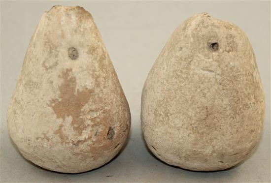 A pair of Greek stone loom weights, c.3rd century BC, 8.5cm and 9.5cm